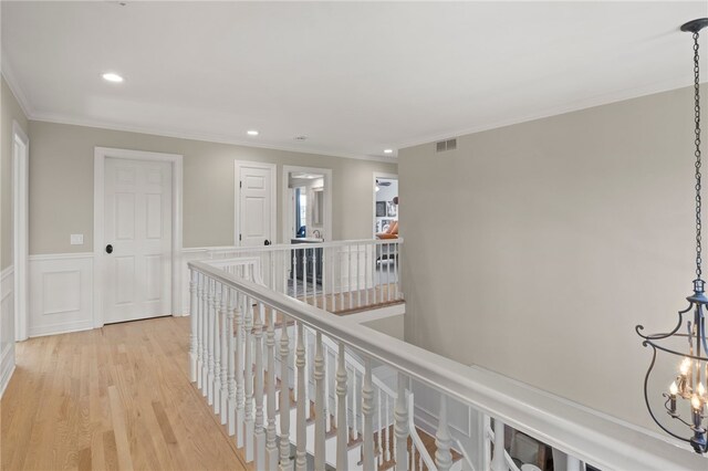corridor with visible vents, recessed lighting, light wood-style floors, and crown molding