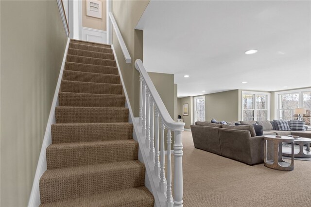 staircase with a wealth of natural light, recessed lighting, and carpet flooring