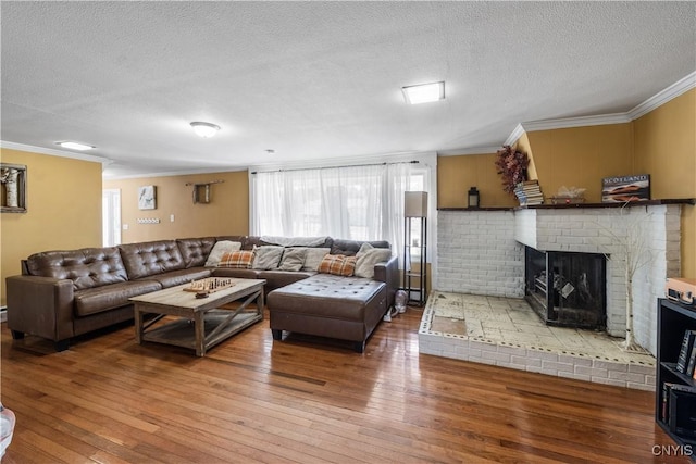 1905 Stump Rd, Skaneateles, NY 13108 - living room featuring a fireplace, a textured ceiling, a baseboard heating unit, ornamental molding, and hardwood / wood-style floors