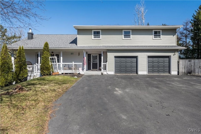 1905 Stump Rd, Skaneateles, NY 13108 - traditional-style home featuring fence, an attached garage, a chimney, driveway, and covered porch