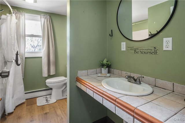 1905 Stump Rd, Skaneateles, NY 13108 - bathroom with vanity, toilet, baseboard heating, curtained shower, and wood finished floors