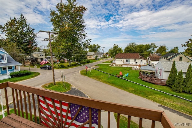 deck featuring a residential view and a lawn