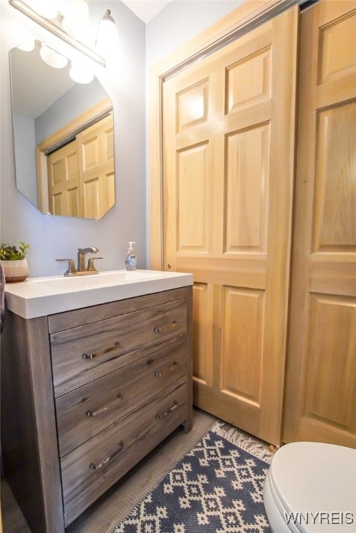 bathroom featuring toilet and vanity