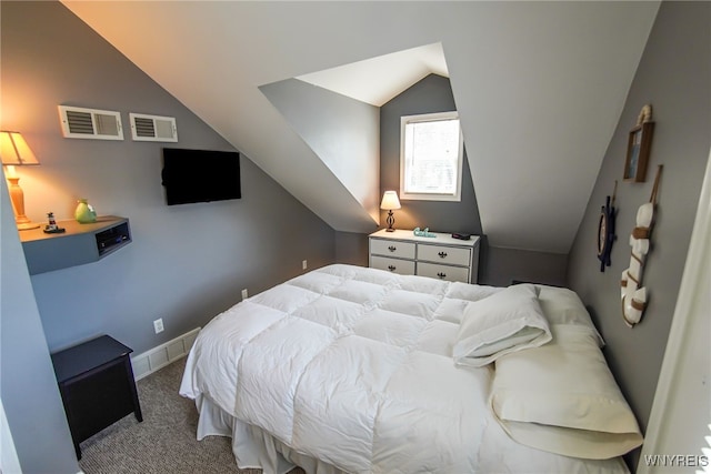 carpeted bedroom with baseboards, visible vents, and vaulted ceiling