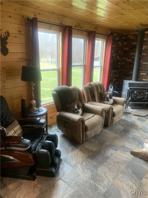 376 State Route 34, Hannibal, NY 13074 - living room with plenty of natural light, wood walls, a wood stove, and wood ceiling
