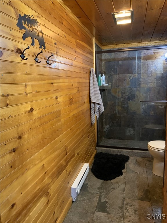 376 State Route 34, Hannibal, NY 13074 - full bathroom with wood walls, a shower stall, a baseboard radiator, toilet, and wood ceiling