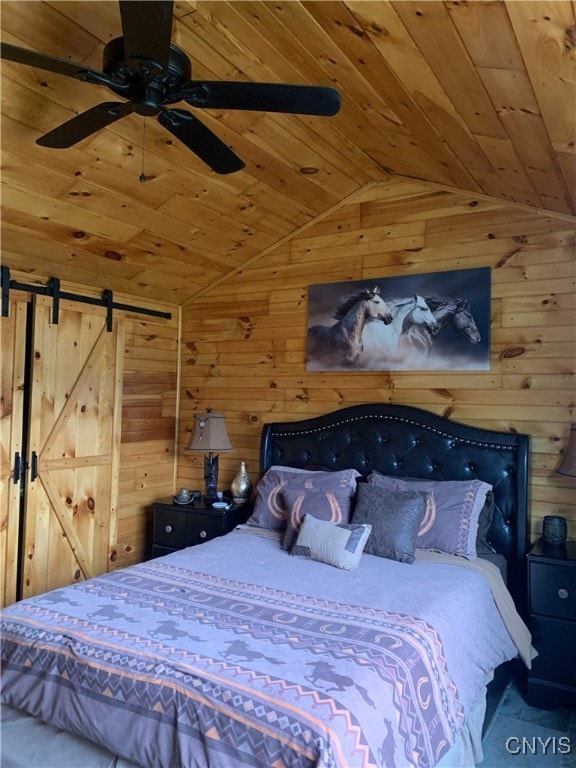 376 State Route 34, Hannibal, NY 13074 - unfurnished bedroom with wood walls, ceiling fan, a barn door, vaulted ceiling, and wood ceiling