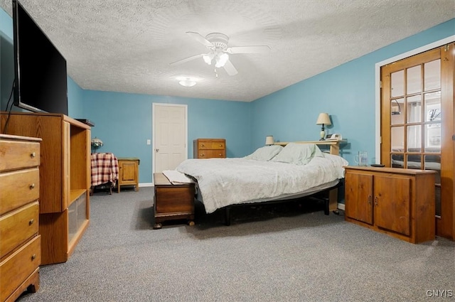 bedroom featuring baseboards, carpet flooring, a textured ceiling, and a ceiling fan