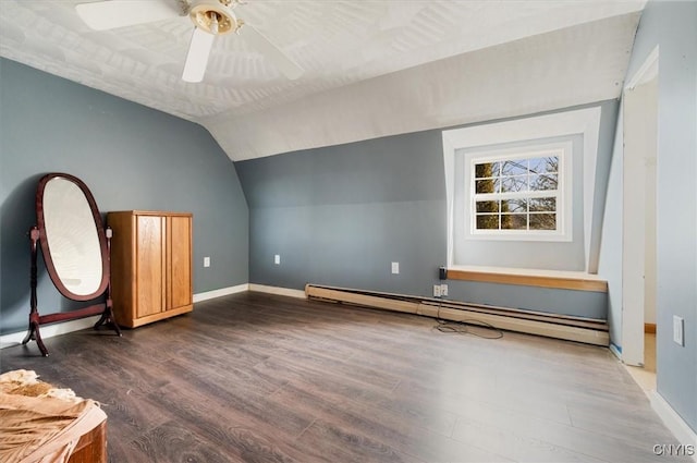 additional living space with lofted ceiling, baseboard heating, baseboards, ceiling fan, and wood finished floors