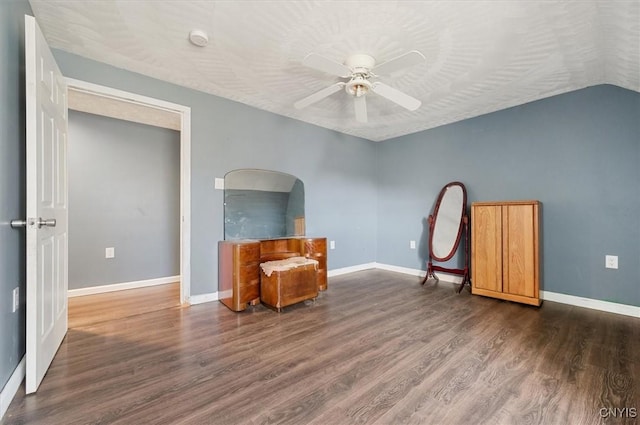 unfurnished room with baseboards, wood finished floors, and a ceiling fan