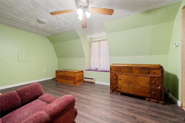 sitting room with vaulted ceiling, a baseboard heating unit, dark wood-type flooring, baseboards, and ceiling fan