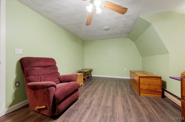 sitting room with wood finished floors, a textured ceiling, lofted ceiling, baseboards, and a baseboard heating unit