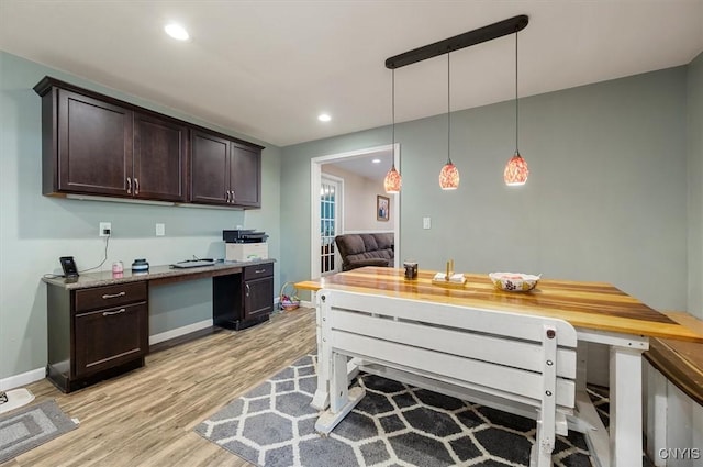 kitchen featuring dark brown cabinetry, light wood-style floors, recessed lighting, and built in study area