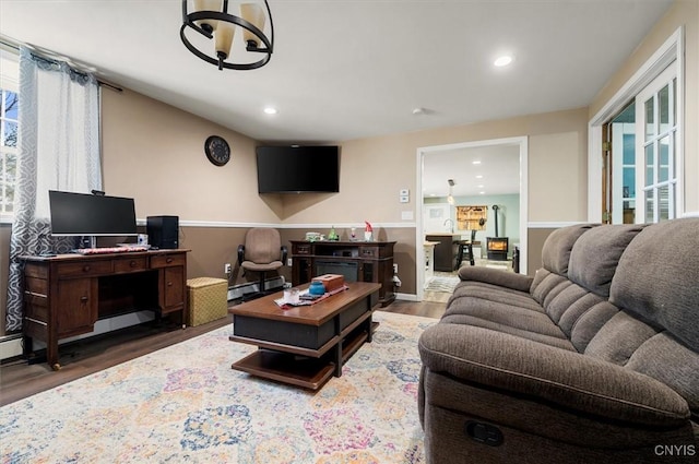 living area with a baseboard radiator, recessed lighting, and wood finished floors