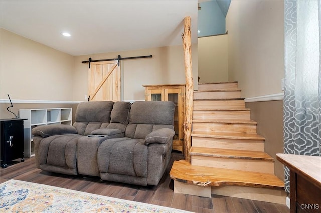 living room featuring recessed lighting, a barn door, stairs, and wood finished floors