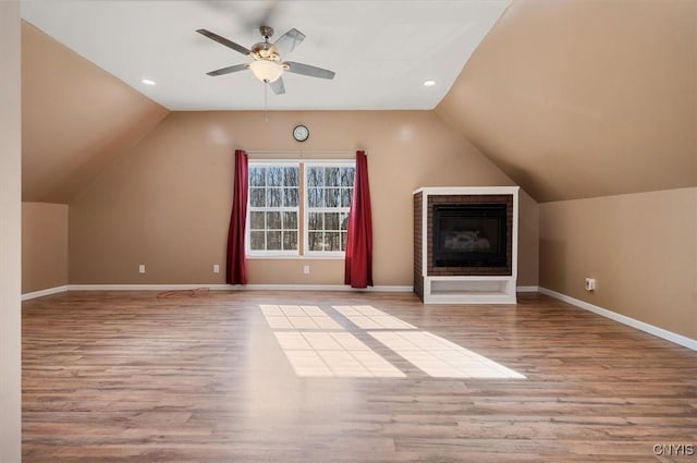 bonus room featuring lofted ceiling, recessed lighting, baseboards, a ceiling fan, and wood finished floors