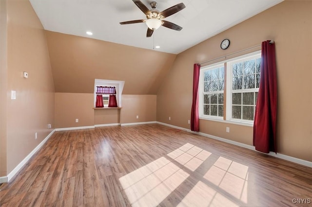 bonus room featuring lofted ceiling, recessed lighting, baseboards, a ceiling fan, and wood finished floors