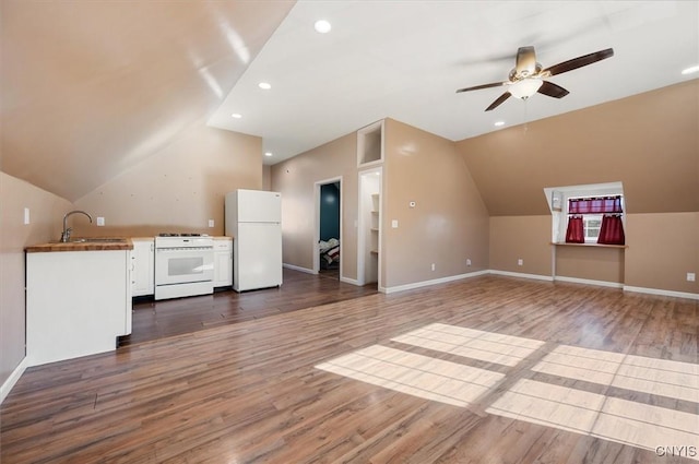 bonus room featuring dark wood-style flooring, ceiling fan, a sink, and lofted ceiling