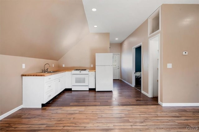 kitchen featuring white appliances, baseboards, a sink, white cabinets, and wood finished floors