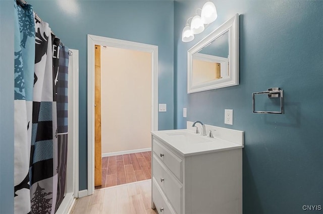 bathroom featuring vanity, curtained shower, baseboards, and wood tiled floor