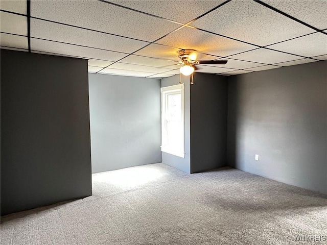 spare room featuring carpet floors, a paneled ceiling, and a ceiling fan