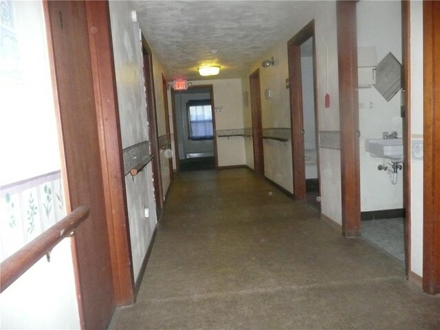 1268 County Road 19, Dix, NY 14812 - hall featuring a textured ceiling, a healthy amount of sunlight, a sink, and baseboards