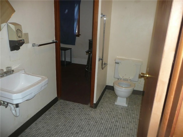 1268 County Road 19, Dix, NY 14812 - bathroom featuring a sink, toilet, tile patterned flooring, and baseboards