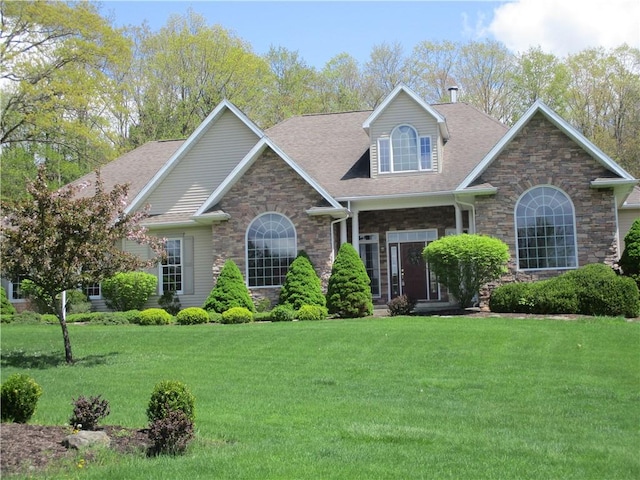 114 Lemae Dr, Catlin, NY 14845 - view of front of home featuring roof with shingles, stone siding, and a front yard