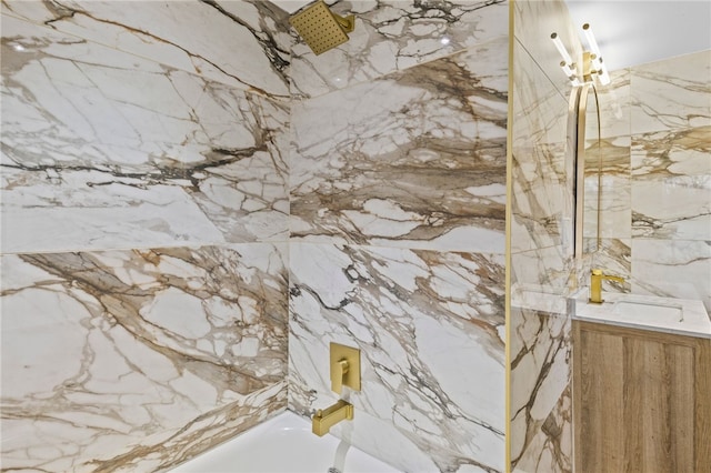 full bath featuring stone wall and vanity