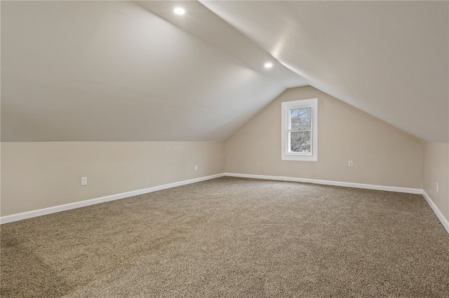 additional living space with baseboards, lofted ceiling, recessed lighting, and carpet flooring