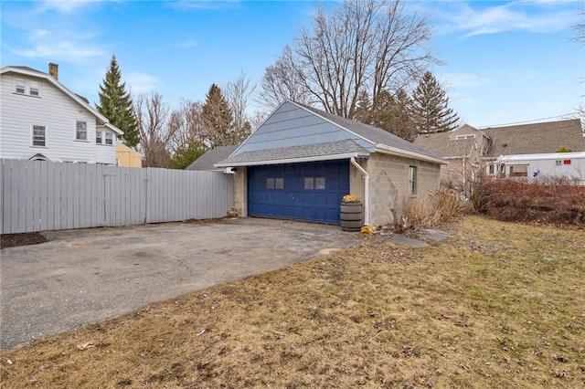 detached garage featuring fence