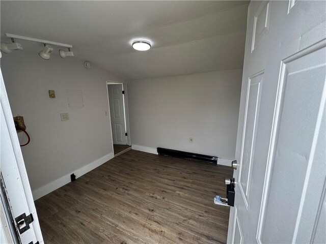 317 W State St, Albion, NY 14411 - empty room with vaulted ceiling and dark wood-style flooring