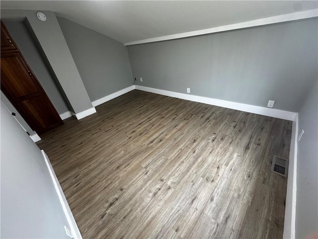 317 W State St, Albion, NY 14411 - additional living space featuring vaulted ceiling and dark wood-style flooring