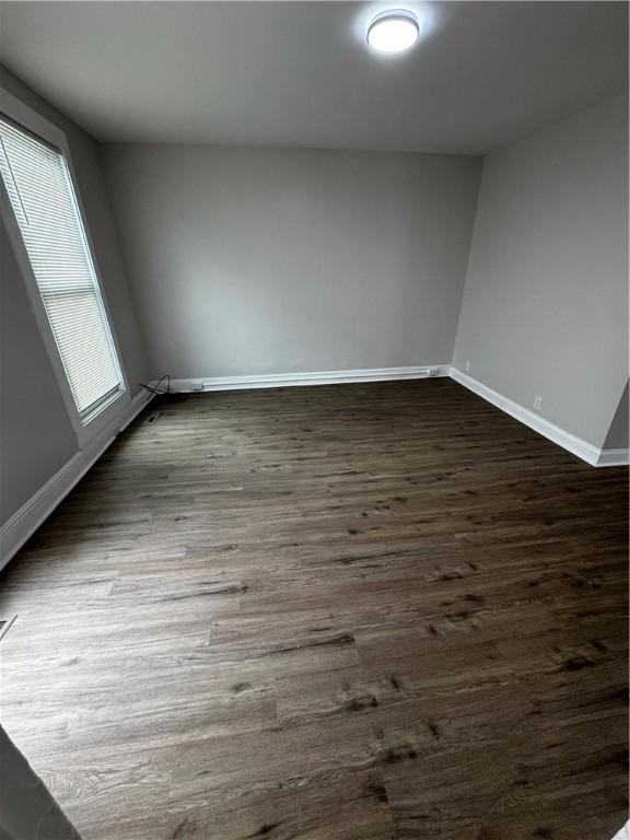 317 W State St, Albion, NY 14411 - empty room featuring baseboards and dark wood finished floors