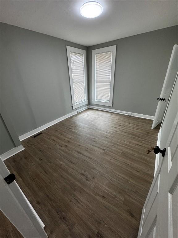 317 W State St, Albion, NY 14411 - unfurnished room with dark wood-style flooring and baseboards