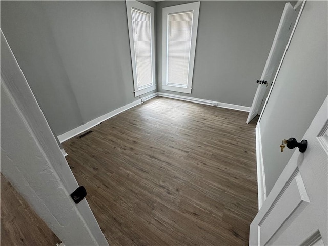 317 W State St, Albion, NY 14411 - spare room featuring baseboards and dark wood-type flooring