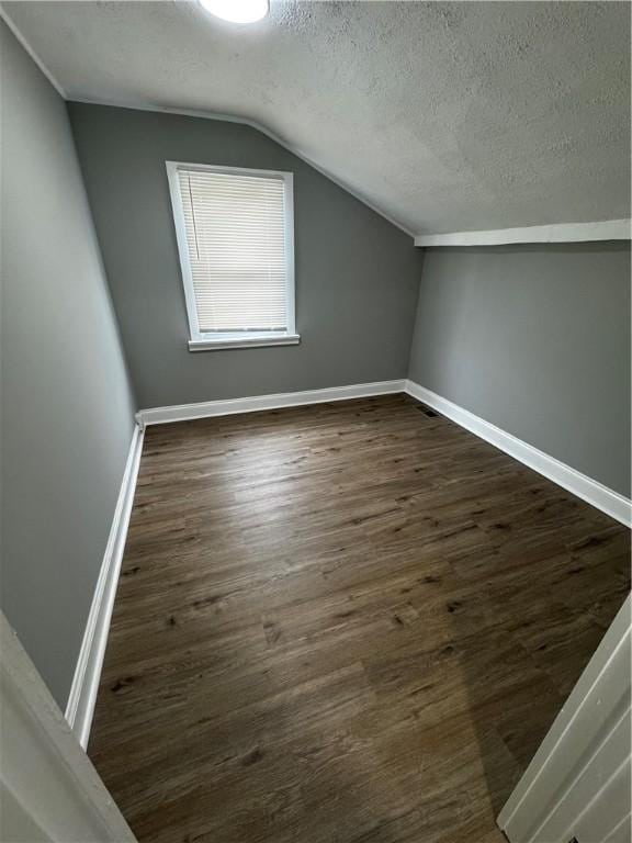 317 W State St, Albion, NY 14411 - bonus room with a textured ceiling, vaulted ceiling, and dark wood finished floors
