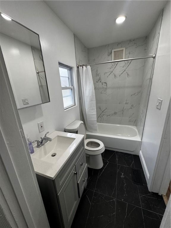 317 W State St, Albion, NY 14411 - bathroom with vanity, marble finish floors, and shower / tub combo