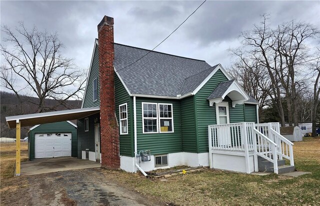 330 Victory Hwy, Erwin, NY 14870 - view of front facade featuring an attached carport, a shingled roof, a chimney, and aphalt driveway