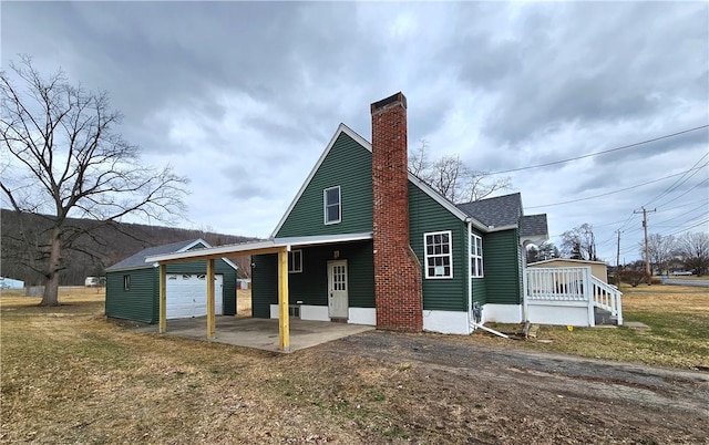 330 Victory Hwy, Erwin, NY 14870 - exterior space with driveway, a front yard, a garage, a shingled roof, and a chimney