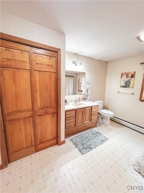 4062 Port St, Richland, NY 13142 - bathroom with a baseboard heating unit, vanity, tile patterned floors, and toilet