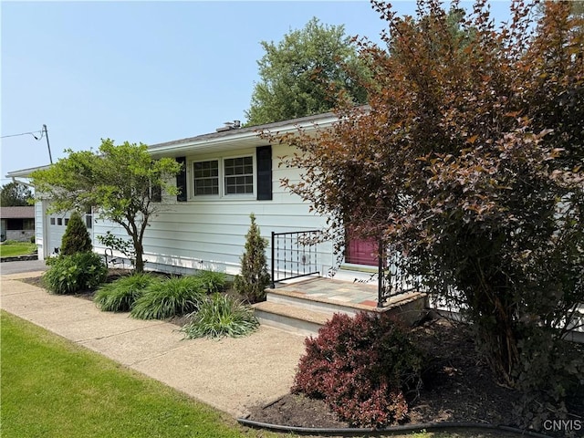 4062 Port St, Richland, NY 13142 - view of property hidden behind natural elements featuring an attached garage