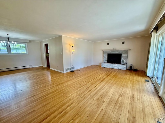 4062 Port St, Richland, NY 13142 - unfurnished living room featuring baseboard heating, light wood-type flooring, a fireplace with raised hearth, a chandelier, and baseboards