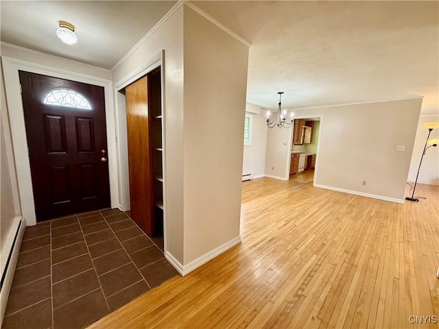 4062 Port St, Richland, NY 13142 - entrance foyer with a chandelier, a baseboard radiator, ornamental molding, hardwood / wood-style floors, and baseboards