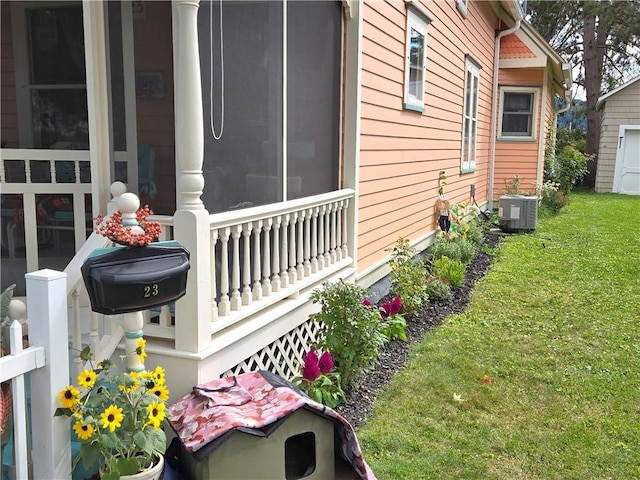 view of property exterior featuring central AC unit and a lawn