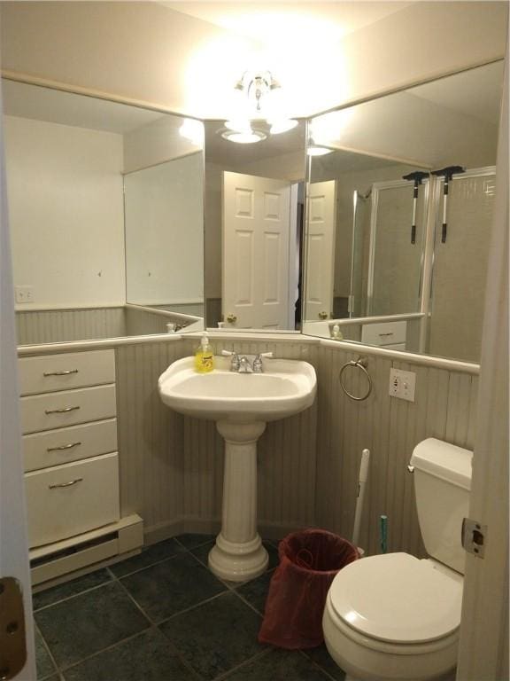 bathroom featuring a baseboard radiator, tile patterned flooring, and toilet