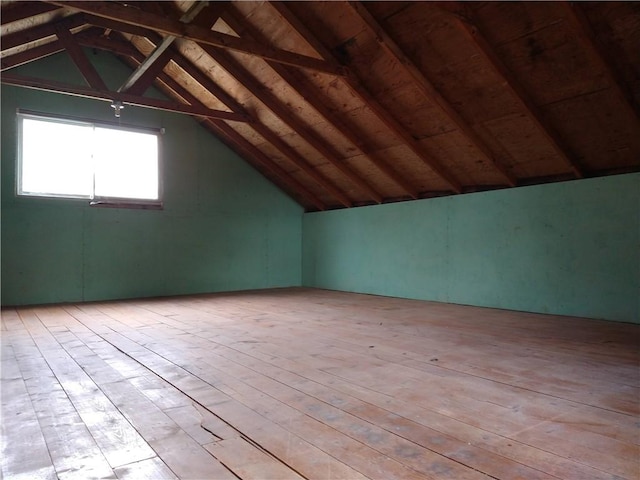 bonus room with hardwood / wood-style floors and lofted ceiling