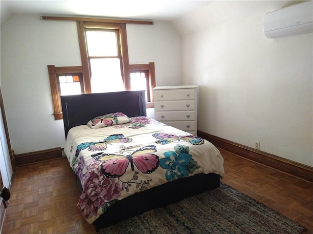 bedroom with baseboards, a wall mounted air conditioner, and vaulted ceiling