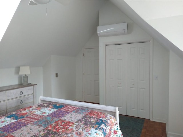 bedroom featuring a ceiling fan, an AC wall unit, a closet, and vaulted ceiling