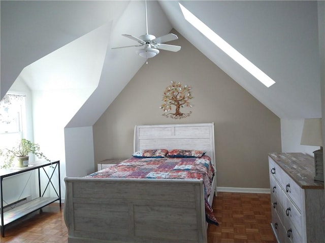 bedroom with baseboards, ceiling fan, and lofted ceiling with skylight